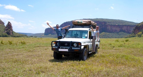 Couple driving in national park in Kenya